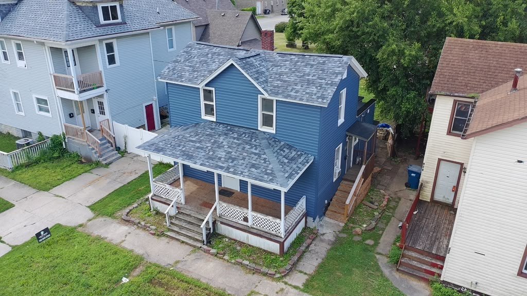 A completed Eagle Star roof on a two-storey Chicagoland home with a wraparound porch