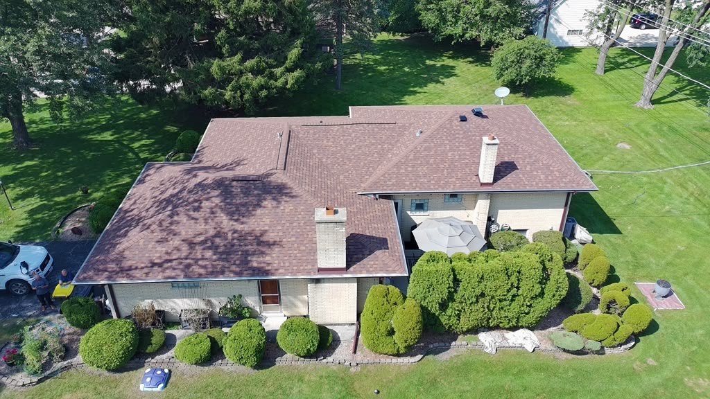 A completed Eagle Star roof in weathered-wood shingles on a large brick Chicagoland home